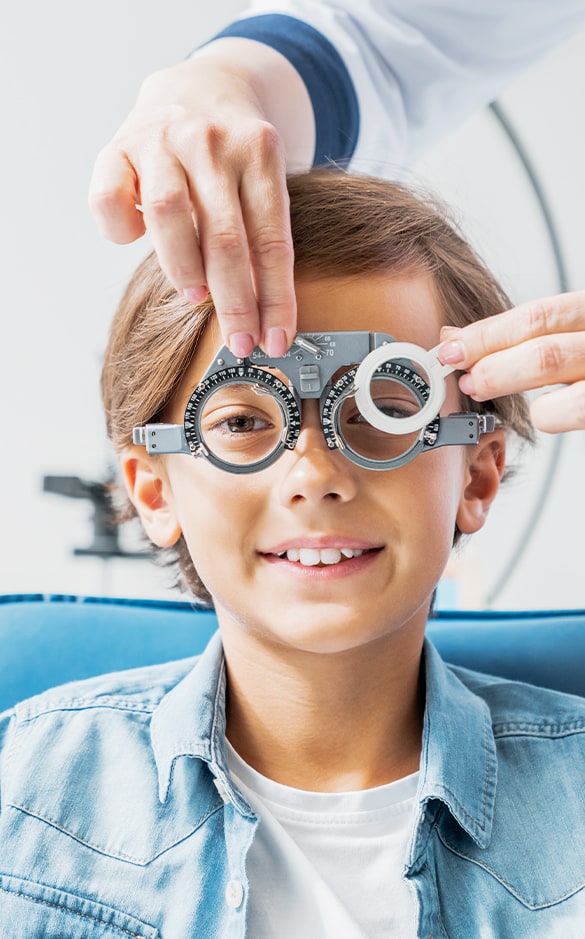 An young boy getting his eyes checked out at an optometrist's office