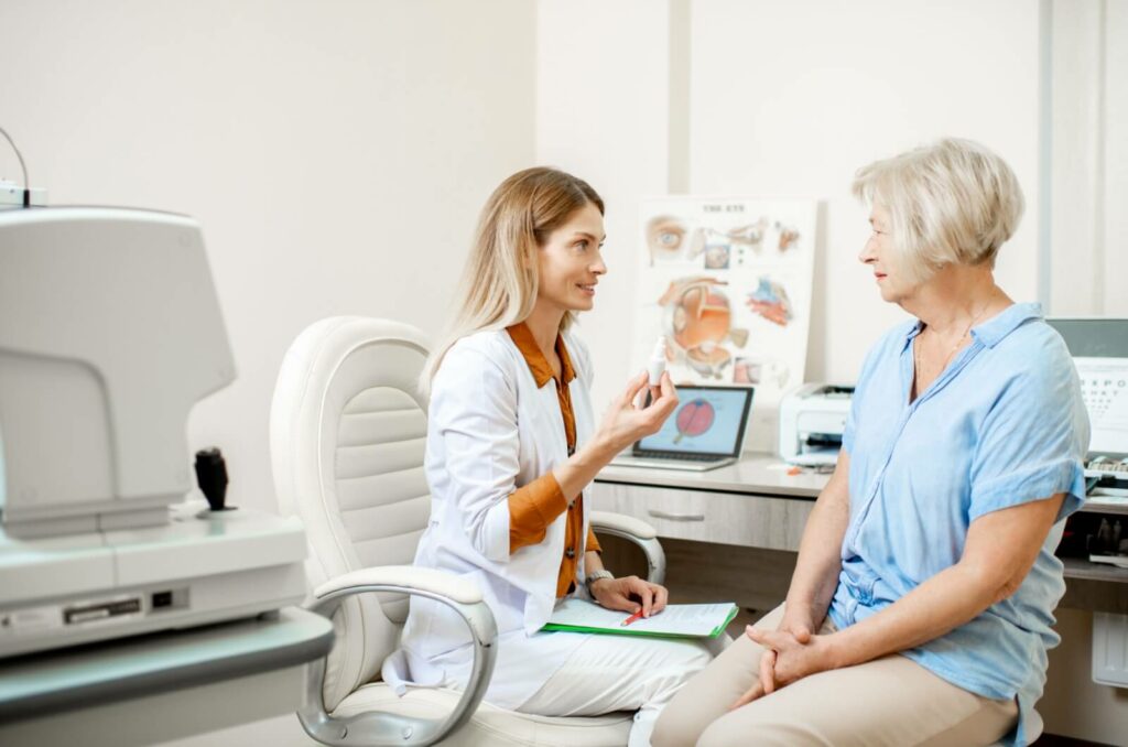 An optometrist discussing dry eye management with their patient.