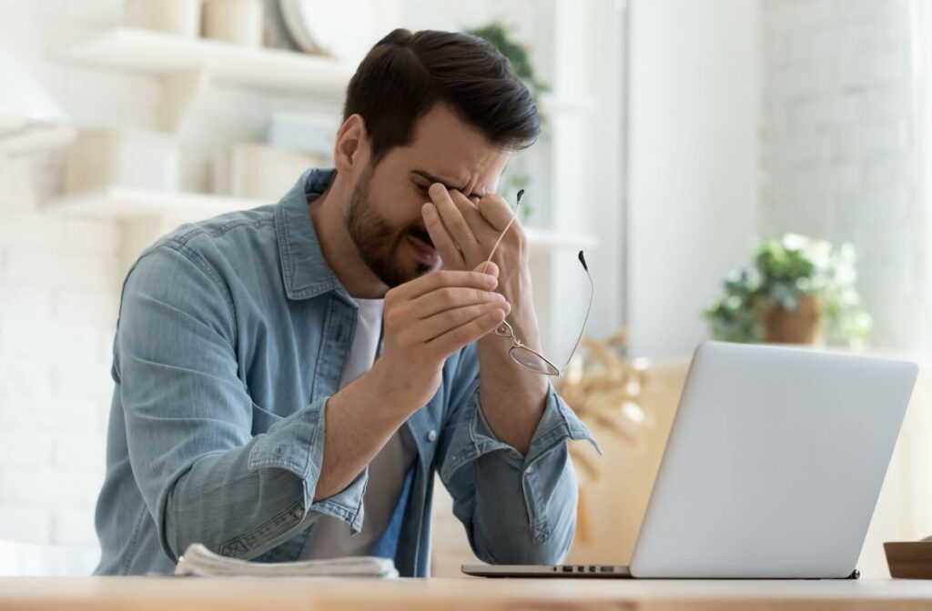 A person rubbing their tired eyes.