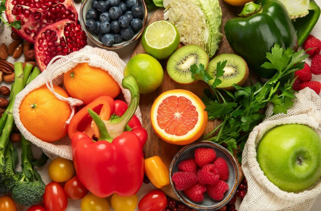 A bunch of vitamin C filled fruits and vegetables on a table.